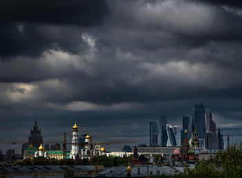 St basil cathedral amidst buildings against cloudy sky in city