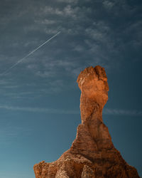 Low angle view of rock formation against sky