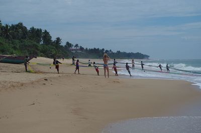 Group of people playing on beach