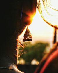 Close-up of man against sky during sunset