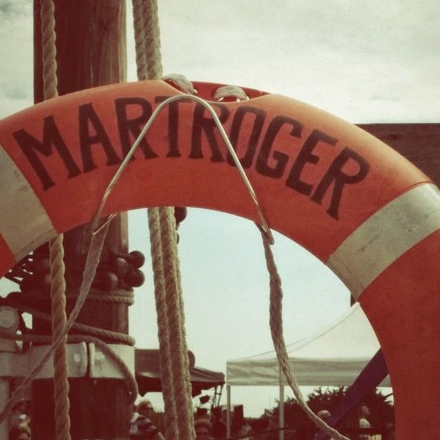 text, red, western script, communication, safety, warning sign, close-up, metal, guidance, sign, road sign, information sign, sky, protection, capital letter, day, rusty, focus on foreground, outdoors, no people