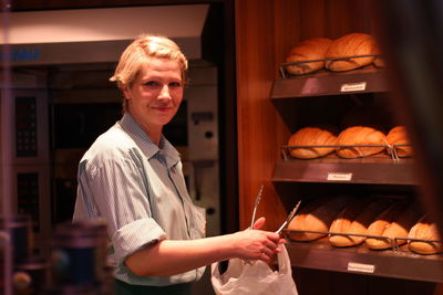 Portrait of smiling baker at workshop