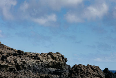 Low angle view of rock formations against sky