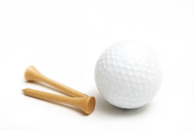 Close-up of balls on table against white background