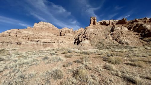 Rock formations on landscape against sky