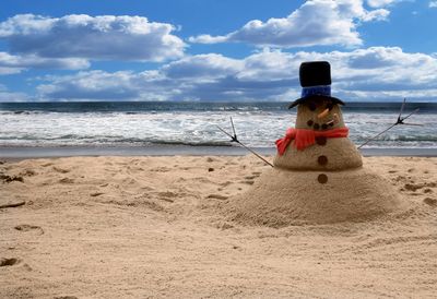 Rear view of man on beach against sky