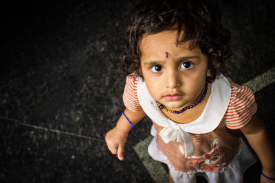 High angle portrait of cute girl holding camera