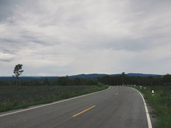 Empty road along countryside landscape
