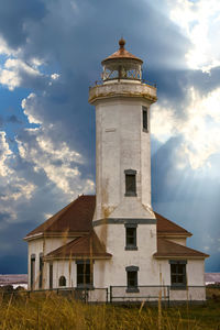 Low angle view of lighthouse against  cloudy sky