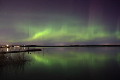 Scenic view of lake against sky at night