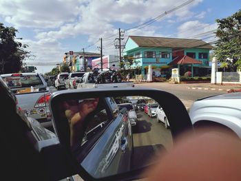 Man driving car on road against sky