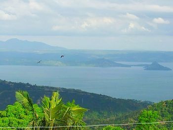 Scenic view of sea against cloudy sky
