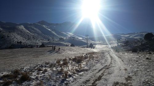 Panoramic view of snow covered landscape against sky