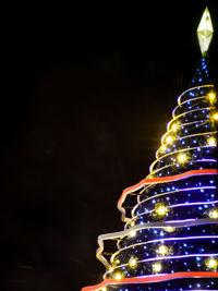 Low angle view of illuminated christmas tree at night