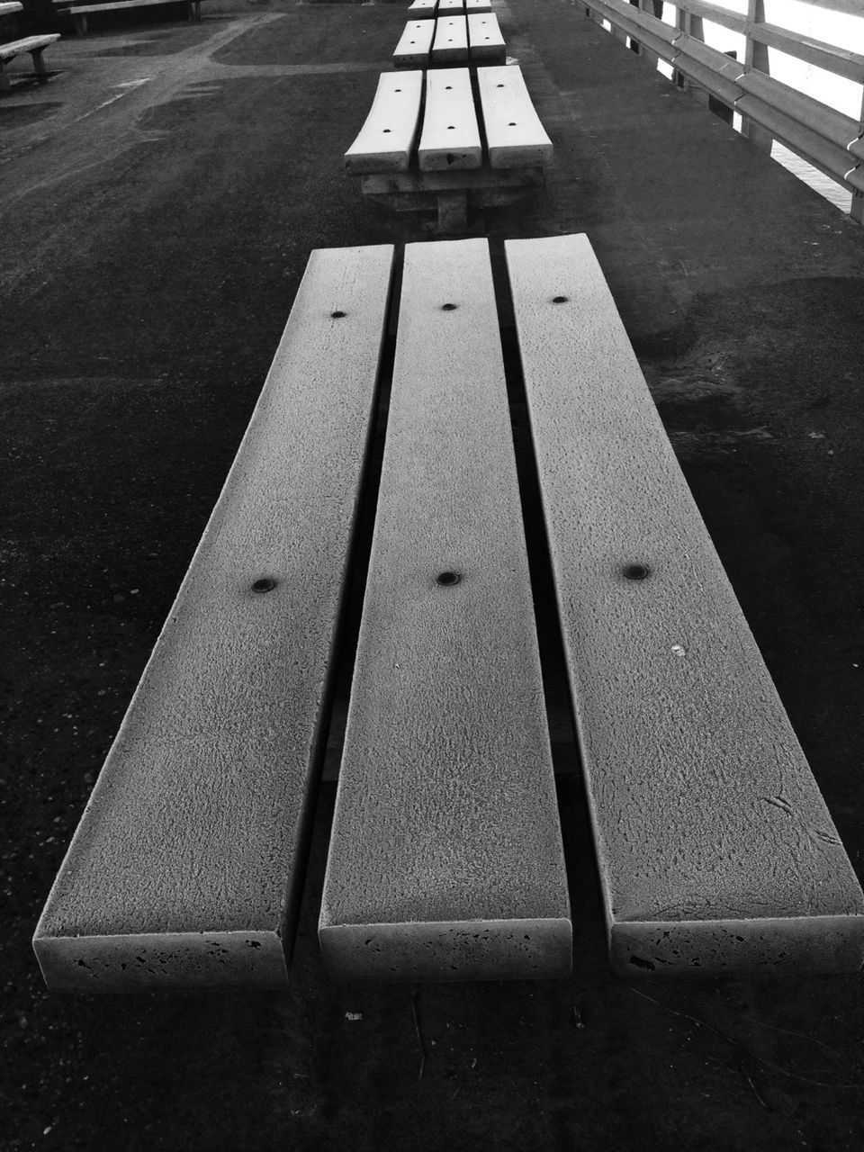 asphalt, road, street, the way forward, road marking, transportation, high angle view, shadow, guidance, diminishing perspective, empty, outdoors, no people, sunlight, surface level, day, vanishing point, railing, direction, sidewalk