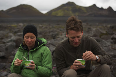 Couple eating icelandic skyr on a hiking break on laugavegur trek