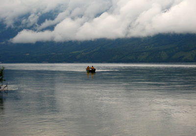 Boat sailing in sea against sky