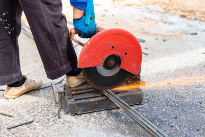 Worker use electric fiber cutting steel bar .with sparks go ahead in building construction site..