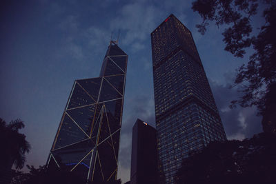 Low angle view of buildings against cloudy sky