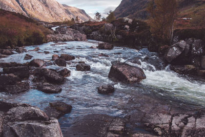 Scenic view of river flowing through rocks