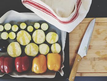 High angle view of fruits and cutting board on table