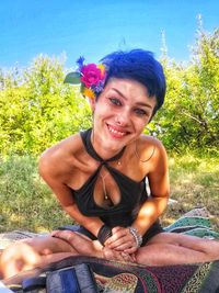 Portrait of a smiling young woman sitting outdoors
