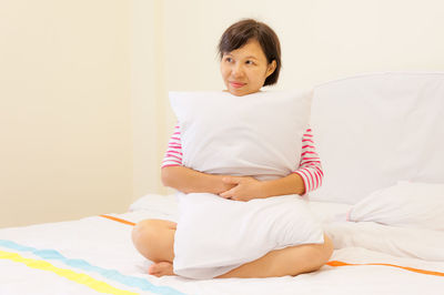 Woman sitting on bed