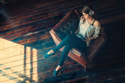 Portrait of young woman sitting on chair