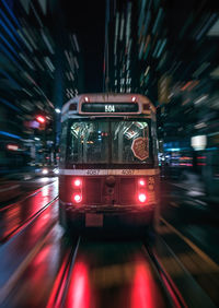 Blurred motion of illuminated bus at night