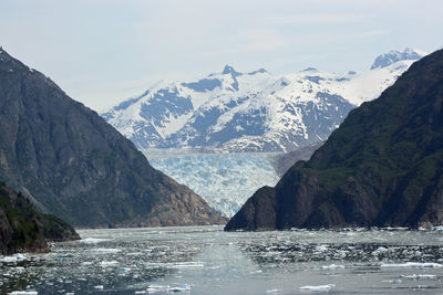 Scenic view of sea and mountains against sky