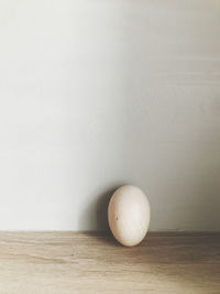 Close-up of fruit on table against wall