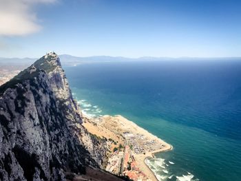 Scenic view of sea and mountains against sky