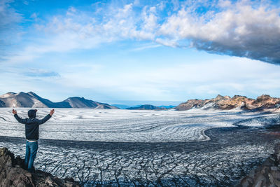 Scenic view of glacier inside volcano crater against sky