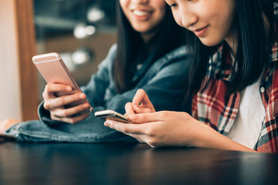 Midsection of woman using mobile phone