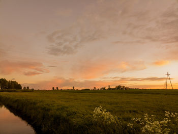 Scenic view of field against sky during sunset