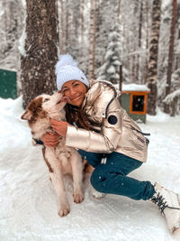 Portrait of woman standing in snow