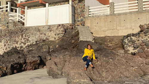 Full length of woman on wall of building