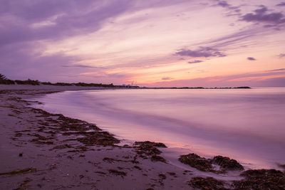 Scenic view of sea against romantic sky at sunset