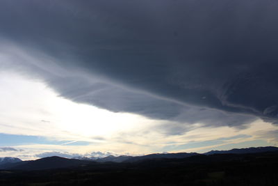 Scenic view of silhouette mountains against sky at sunset