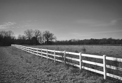 Fence on field against sky