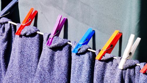 Close-up of purple towels drying on clothesline