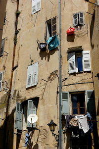 Low angle view of clothes drying on old building