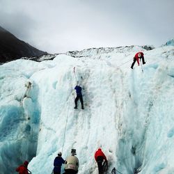 People standing on snow covered mountain