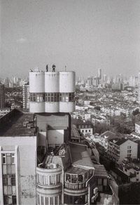High angle view of buildings in city against sky