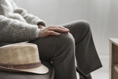 Midsection of woman sitting on chair