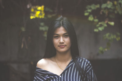 Portrait of young woman standing outdoors