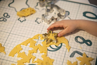 Cropped hand of person holding jigsaw puzzle