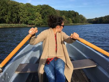 Woman rowing boat in lake