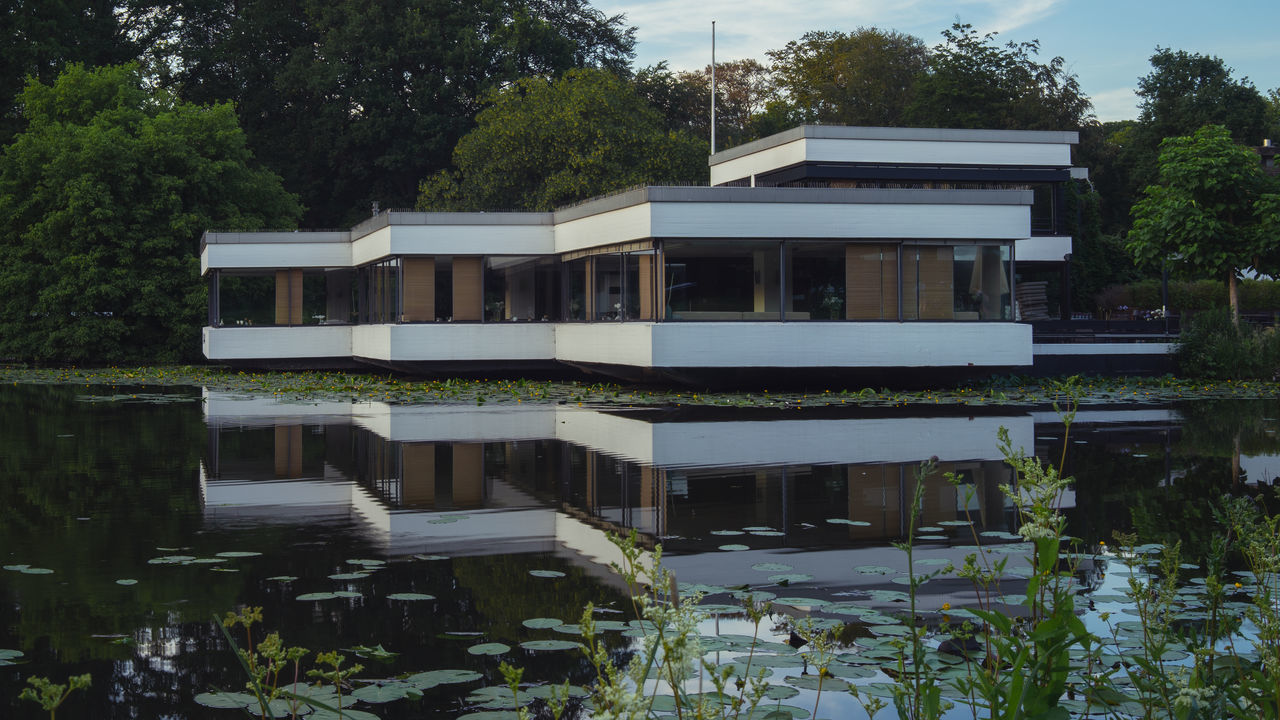 BUILDINGS BY SWIMMING POOL AGAINST TREES