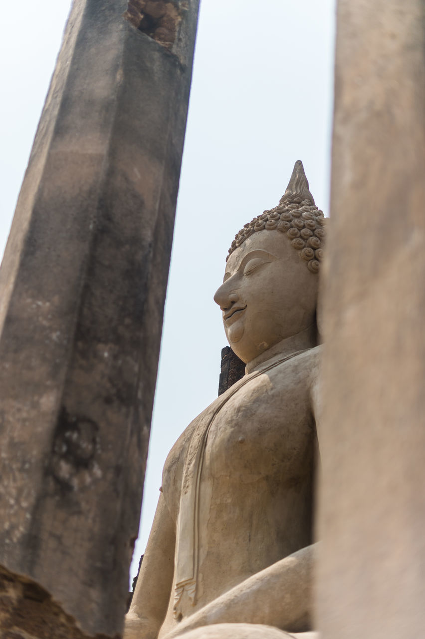 LOW ANGLE VIEW OF A STATUE OF A TEMPLE